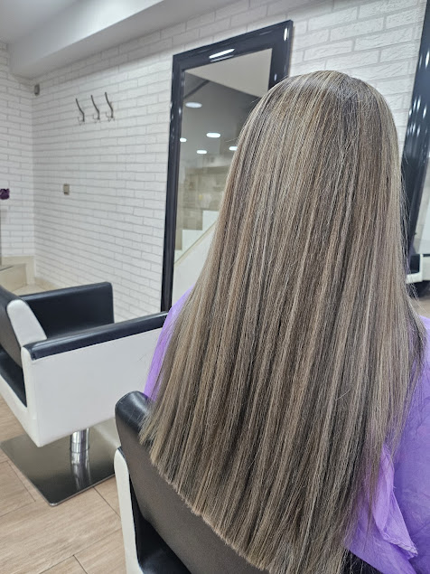 Cabello largo y liso de cliente después de un tratamiento en el salón de peluquería en Vélez-Málaga.